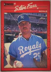 Front of 1990 Donruss Baseball Steve Farr #356 Base, portrait baseball card front. A red speckled border surrounds a large color photograph of a Kansas City Royals pitcher holding a baseball and glove…