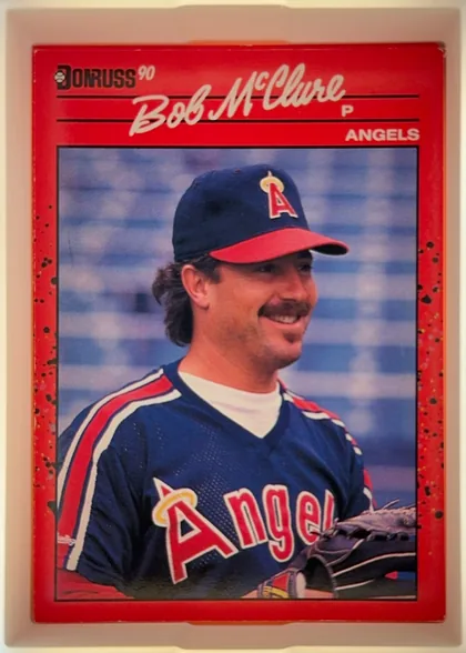 Front of 1990 Donruss Bob McClure #470, upright portrait baseball card. The upper red header displays the Donruss logo and "90" at left, a large cream script player name "Bob McClure"…