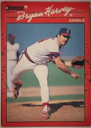 Front of 1990 Donruss Bryan Harvey #372, upright portrait baseball card front. A red border surrounds a large color photograph of a pitcher in an Angels uniform delivering a pitch. The…