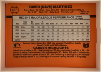 Back of 1990 Donruss Dave Martinez #452, orange baseball-card back dominated by a black horizontal stripe and a large gray, black-bordered statistics table. The player name is centered…