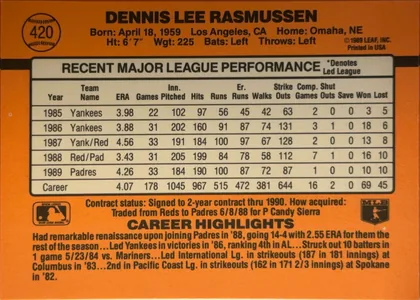 Back of 1990 Donruss Dennis Lee Rasmussen #420, landscape-oriented baseball card back. An orange field surrounds a large cream statistics table in the center. The player's name is printed in bold…