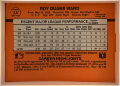 Back of 1990 Donruss Duane Ward #307, landscape-oriented baseball card back with an orange field. The upper area prominently names Roy Duane Ward and shows biographical information. A…