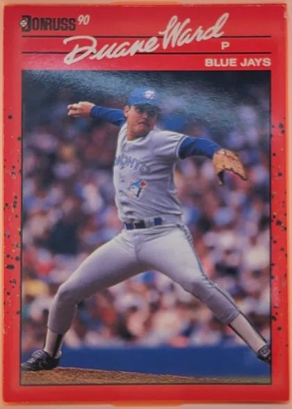 Front of 1990 Donruss Duane Ward #307, upright portrait baseball card. A large action photograph shows a pitcher in a Blue Jays uniform delivering a pitch. The top has a red header with…