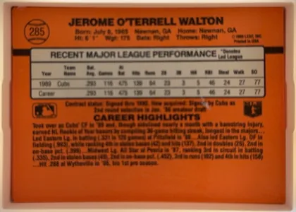 Back of 1990 Donruss Jerome Walton #285, landscape-oriented orange baseball card back. The player name is centered across the top, with biographical details beneath it. A baseball graphic…