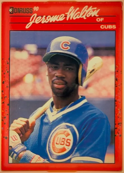 Front of 1990 Donruss Jerome Walton #285, upright portrait baseball card. A large color photograph shows a Cubs player in a blue uniform and batting helmet holding a bat. The top area has a…