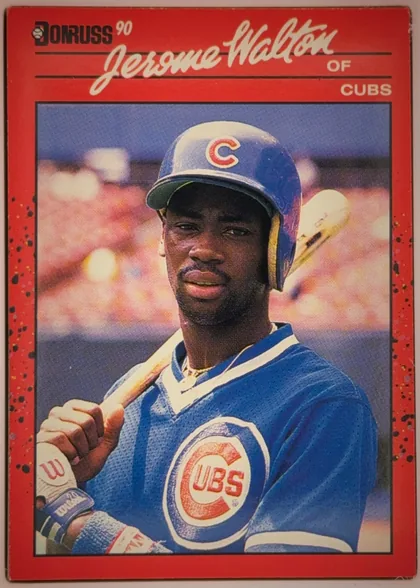 Front of 1990 Donruss Jerome Walton #285, portrait baseball card front. A large color photograph shows a Chicago Cubs player in blue uniform and helmet holding a bat. The top red header…