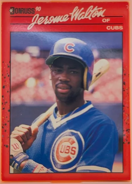 Front of 1990 Donruss Jerome Walton #285, portrait baseball card front. A red border surrounds a large color photograph of Jerome Walton in a blue Chicago Cubs uniform and batting helmet…