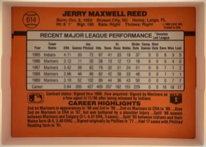 Back of 1990 Donruss Jerry Reed #614, back side in landscape orientation. Orange-red field with a prominent black horizontal stripe near the upper portion. The player name is centered…