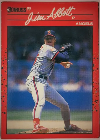 Front of 1990 Donruss Jim Abbott #108 Base, portrait baseball card front. A prominent white script player name, "Jim Abbott," spans the upper portion, with a small "P" and "ANGELS" at upper…