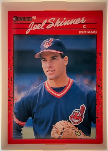 Front of 1990 Donruss Joel Skinner #73, portrait baseball card front. A red header contains the Donruss logo and "90" at upper left, the large white script name "Joel Skinner" across the…
