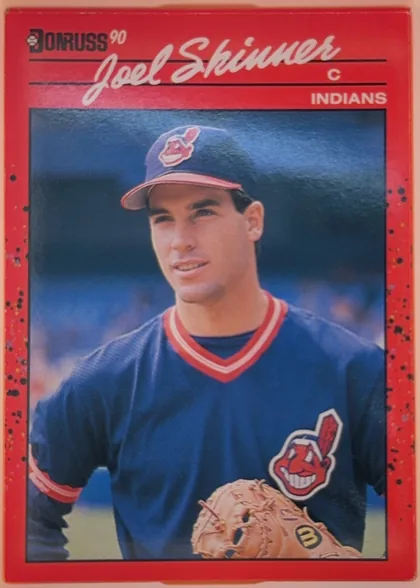 Front of 1990 Donruss Joel Skinner #73, upright portrait baseball card front. A large color photograph shows Joel Skinner in a Cleveland Indians uniform and cap, holding a glove. The top…