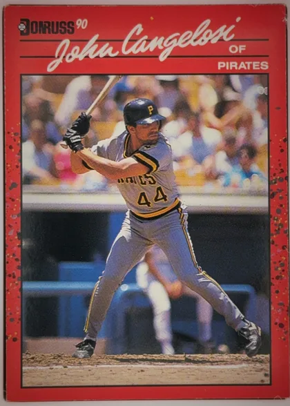 Front of 1990 Donruss John Cangelosi #565 Base, upright portrait baseball card. The upper red header contains the Donruss logo and "90" at left, a large white script player name across the top…
