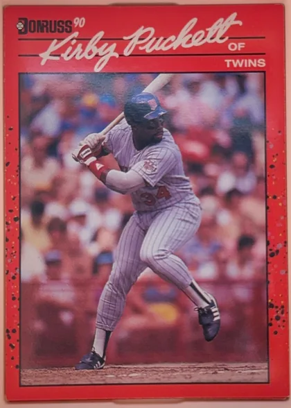 Front of 1990 Donruss Kirby Puckett #269, portrait-oriented baseball card front. The upper section has the Donruss logo and '90' at upper left, with the large white script name 'Kirby…