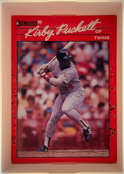Front of 1990 Donruss Kirby Puckett #269, portrait baseball card front. A red header contains the Donruss logo and "90" at upper left, the large cream script name "Kirby Puckett" across the…