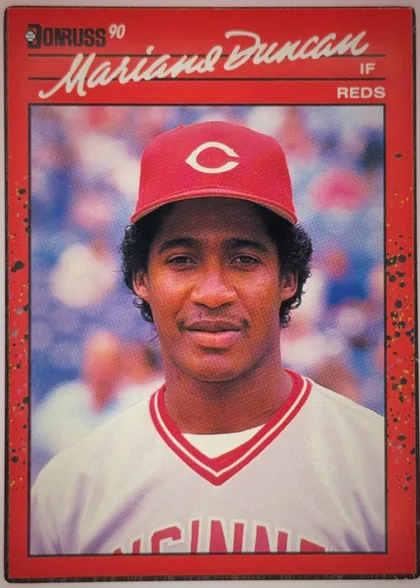 Front of 1990 Donruss Mariano Duncan #684, portrait-oriented baseball player card. The upper left has a Donruss logo and "90"; the large white script name "Mariano Duncan" spans the upper…