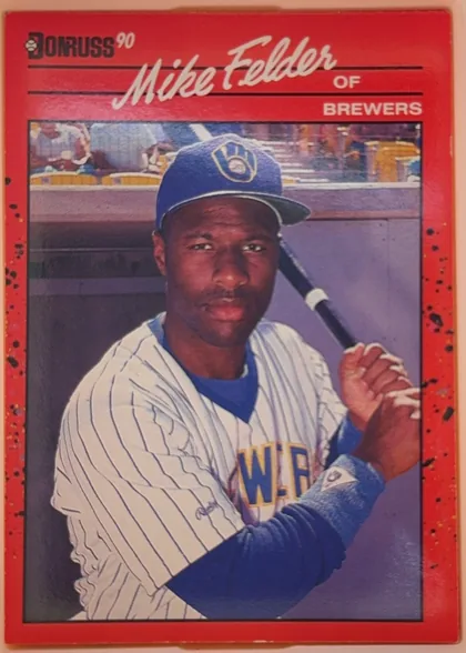 Front of 1990 Donruss Mike Felder #609, portrait-oriented baseball card front. The upper red header contains the black Donruss logo and white "90," with the player's name "Mike Felder" in…
