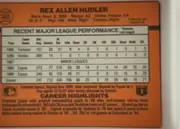 Back of 1990 Donruss Rex Hudler #366, landscape-oriented baseball card back dominated by an orange field. The player's name is centered across the top, with biographical details beneath…