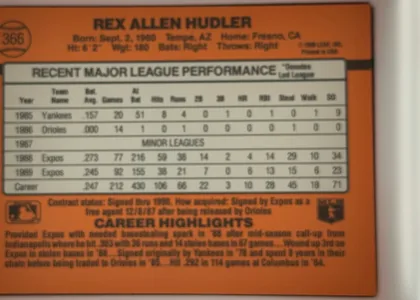 Back of 1990 Donruss Rex Hudler #366, landscape-oriented baseball card back dominated by an orange field. The player's name is centered across the top, with biographical details beneath…