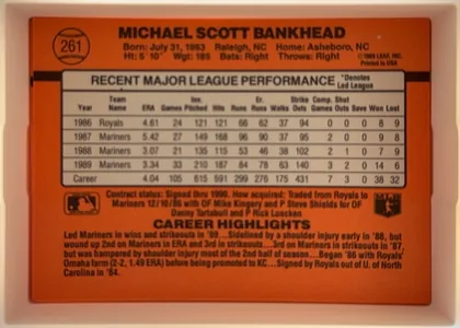 Back of 1990 Donruss Scott Bankhead #261, landscape baseball card back on a solid orange field. Across the top in large black uppercase is the player's full name 'MICHAEL SCOTT BANKHEAD'…
