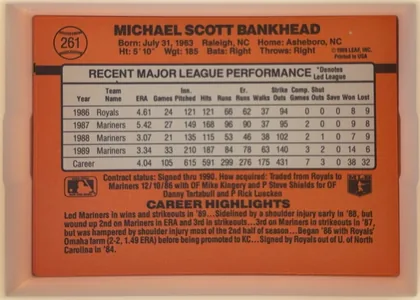 Back of 1990 Donruss Scott Bankhead #261, landscape-oriented baseball card back dominated by an orange-red field. The player's name is printed in large black capitals across the top. A…