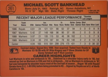 Back of 1990 Donruss Scott Bankhead #261, landscape-oriented baseball card back dominated by an orange-red field. The player's name is printed in large black capitals across the top. A…