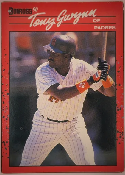 Front of 1990 Leaf Donruss Anthony (Tony) Keith Gwynn #86 Base, portrait-oriented baseball card front. A red speckled border surrounds a large action photograph of Tony Gwynn batting in a Padres uniform. The…