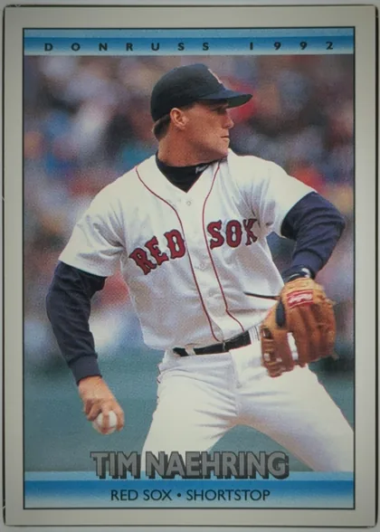 Front of 1991 Donruss Baseball Cards TIMOTHY JAMES NAEHRING #742 Base, portrait baseball card front. A color action photograph shows Tim Naehring in a Boston Red Sox uniform holding a baseball and glove. The top blue…