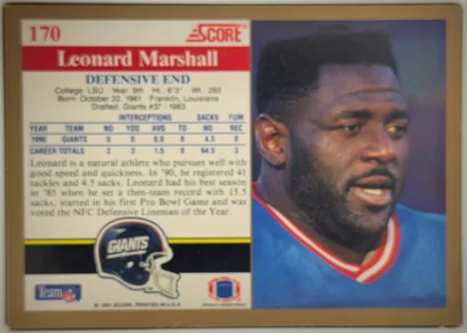 Back of 1991 Score Football Cards Leonard Marshall #170 Base, landscape-oriented football card back. The upper-left area shows card number 170 and a red SCORE logo. A red horizontal banner contains the large…