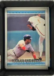 Front of 1992 Donruss Baseball Cards Carlos Quintana #609, portrait baseball card front. A large action photograph shows a Boston player sliding near first base, with another player visible in the upper…