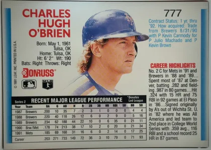 Back of 1992 Donruss Baseball Charlie O'Brien #777 Base, landscape-oriented baseball card back. A large color portrait of Charles Hugh O'Brien occupies the center, with his name in large red type at upper…