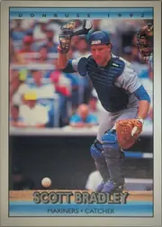 Front of 1992 Donruss Baseball Scott Bradley #713 Base, upright portrait baseball card. The top light-blue band reads DONRUSS 1992. The center shows a catcher in full protective gear crouching behind home…