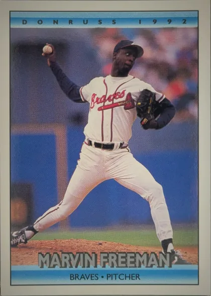 Front of 1992 Donruss Marvin Freeman #603 Base, portrait-oriented baseball card front. A photograph shows a pitcher in a white Atlanta Braves uniform delivering a pitch. The top blue band reads…