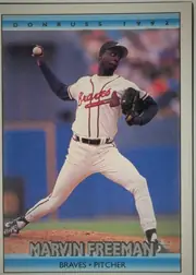 Front of 1992 Donruss Marvin Freeman #603, portrait-oriented baseball card front. A large action photograph shows a pitcher in a Braves uniform throwing a baseball. The top blue band reads…