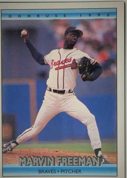 Front of 1992 Donruss Marvin Freeman #603, portrait-oriented baseball card front. A large action photograph shows a pitcher in a Braves uniform throwing a baseball. The top blue band reads…