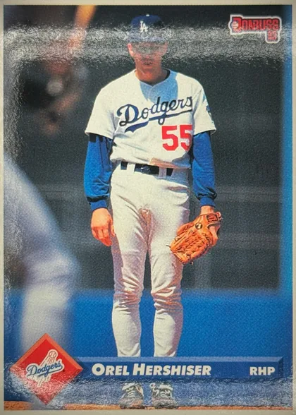Front of 1993 Donruss Baseball Orel Hershiser #274 Base, portrait baseball card front showing a full-body Los Angeles Dodgers player in a white uniform with blue sleeves and number 55. The Donruss logo is…