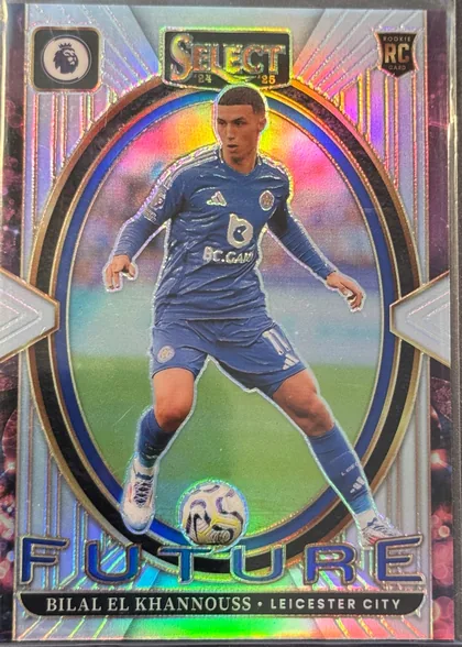 Front of 2024-25 Panini Select Premier League Soccer Bilal El Khannouss #19 Prizm, upright portrait soccer card front. A full-body image of Bilal El Khannouss in a blue Leicester City kit appears in the center, controlling a soccer…