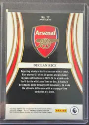 Back of 2024-25 Panini Select Premier League Soccer Declan Rice #17 Prizm, upright portrait-format card back featuring the Arsenal crest centered in the upper half on a black background. "No. 17" and "PRIZM" are printed…