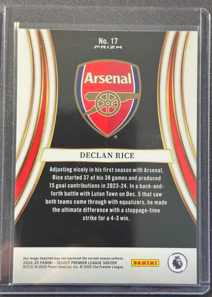 Back of 2024-25 Panini Select Premier League Soccer Declan Rice #17 Prizm, upright portrait-format card back featuring the Arsenal crest centered in the upper half on a black background. "No. 17" and "PRIZM" are printed…