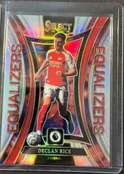 Front of 2024-25 Panini Select Premier League Soccer Declan Rice #17 Prizm, portrait soccer card with a dramatic reflective foil design. The SELECT logo and 24/25 season mark are at the top. Declan Rice is pictured in an…