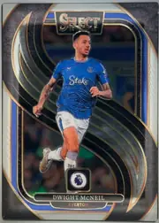 Front of 2024-25 Panini Select Premier League Soccer Dwight McNeil Mezzanine, portrait soccer card front. A player in an Everton blue kit is shown running against a dark background with sweeping black, blue, gold, and silver…