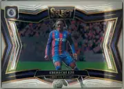 Front of 2024-25 Panini Select Premier League Soccer EBERECHI EZE #215 Field Level, front of a landscape soccer card. A Crystal Palace player with braided hair is shown roughly knees-up in the blue-and-red striped NET82 home kit…