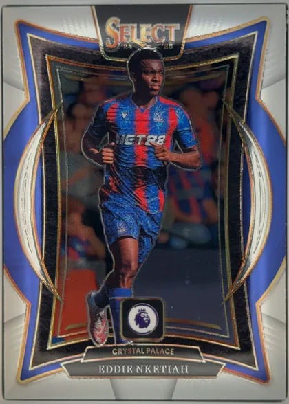 Front of 2024-25 Panini Select Premier League Soccer Eddie Nketiah #76 Base Terrace, portrait soccer card front. A player in a blue-and-red Crystal Palace kit is centered within an ornate reflective black, blue, gold, and white…