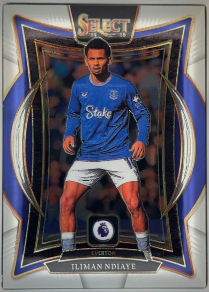 Front of 2024-25 Panini Select Premier League Soccer Iliman Ndiaye #58, upright portrait soccer card front. A central image shows Iliman Ndiaye in an Everton blue kit, with the sponsor text "Stake" visible on the shirt…