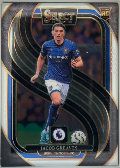 Front of 2024-25 Panini Select Premier League Soccer JACOB GREAVES #119 Mezzanine, front-facing portrait soccer card. A player in a blue Ipswich Town FC kit is pictured running with a ball. The top center has a metallic SELECT logo…