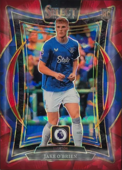 Front of 2024-25 Panini Select Premier League Soccer Jake O'Brien #57 Rookie Card, portrait soccer card front. A centered player in an Everton blue kit stands against a blurred stadium background. SELECT with 24 25 is printed at…