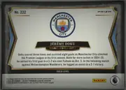 Back of 2024-25 Panini Select Premier League Soccer JÉRÉMY DOKU #222 Field Level Prizm, landscape-oriented statistics/biographical back with a large Manchester City crest centered near the top, the player name in a black banner, team…