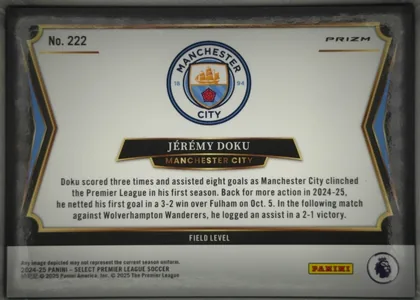 Back of 2024-25 Panini Select Premier League Soccer JÉRÉMY DOKU #222 Field Level Prizm, landscape-oriented statistics/biographical back with a large Manchester City crest centered near the top, the player name in a black banner, team…