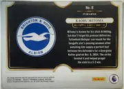 Back of 2024-25 Panini Select Premier League Soccer Kaoru Mitoma #8 Prizm, back of a soccer card with a predominantly black field and gold ornamental border. A large Brighton & Hove Albion crest occupies the left side. On…