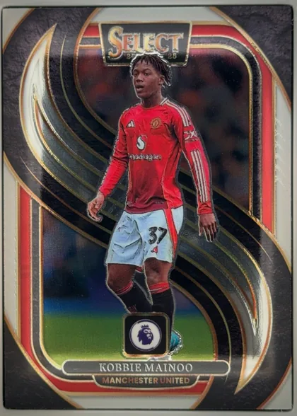 Front of 2024-25 Panini Select Premier League Soccer Kobbie Mainoo #199 Mezzanine, portrait football card front. A full-body image of Kobbie Mainoo in a red Manchester United kit occupies the center, with the number 37 visible on…