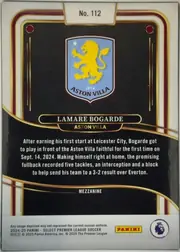 Back of 2024-25 Panini Select Premier League Soccer Lamare Bogarde #112 Mezzanine, portrait-oriented card back. A white tab at the upper center displays "No. 112". The upper black panel contains the Aston Villa crest. A gold-edged…